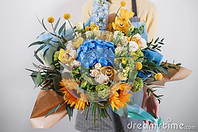 Rich bunch of flowers, green leaf in hand Fresh spring bouquet. Summer Background. Stock Photo
