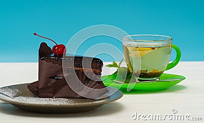 Rich glazed chocolate cake with cup of tea Stock Photo