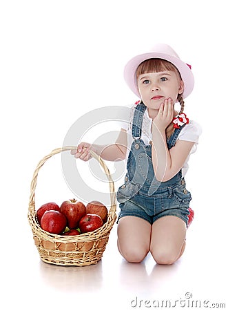 Rich harvest of apples lies in the basket which Stock Photo