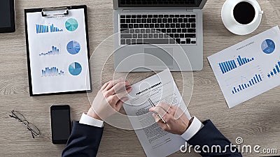 Rich male reading and learning purchase agreement in office, business, top view Stock Photo
