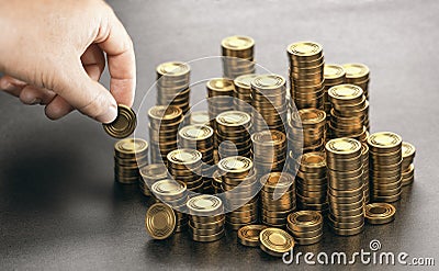 Rich man stacking golden money coins. Income saving plan Stock Photo