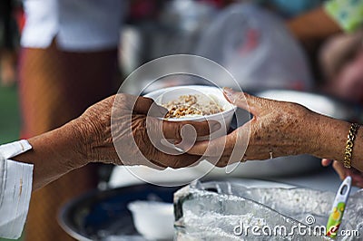 Rich people give food to the poor. starvation concept Stock Photo