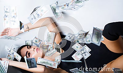 Rich sexy woman lies on money. Currency, women, winning. Sexy female and dollar bills. Sexy woman lying in dollar bills Stock Photo