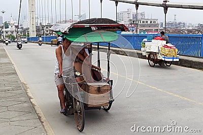 Rickshaw pullers ride manpower tricycle on jingjiang bridge Editorial Stock Photo