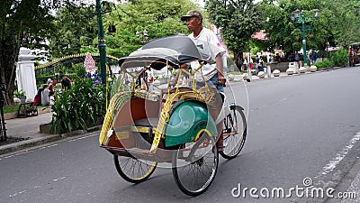 Rickshaws on Jalan Malioboro are a mode of transportation in Yogyakarta Indonesia: Yogyakarta-Indonesia, December 27, 2022 Editorial Stock Photo