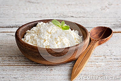 Ricotta cheese, curd cheese, farmers cheese or tvorog in wooden bowl Stock Photo