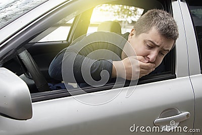 A ride during a car trip. The driver suffers from kinetosis, motion sickness. The concept of motion sickness in transport and Stock Photo