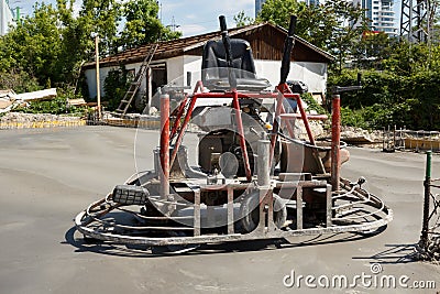 Ride on dual power trowel machine over freshly polished concrete Stock Photo