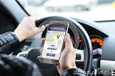 Ride share driver in car using the rideshare app in mobile phone. Stock Photo