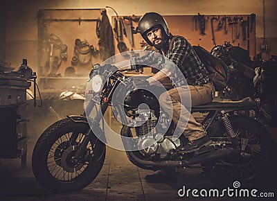 Rider and his vintage style cafe-racer motorcycle Stock Photo