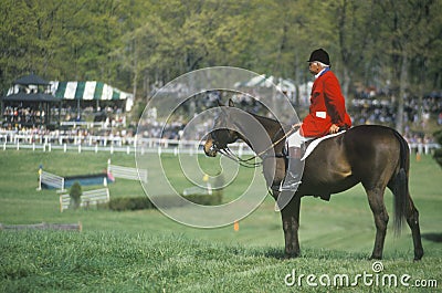 Rider on horseback observing steeplechase field, Prind Steeplechase Glenwood Park, Middleburg, Virginia Editorial Stock Photo