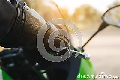 Rider with your hand on the throttle or brake on the handlebar of your motorcycle and your protective gear on. Copy space Stock Photo