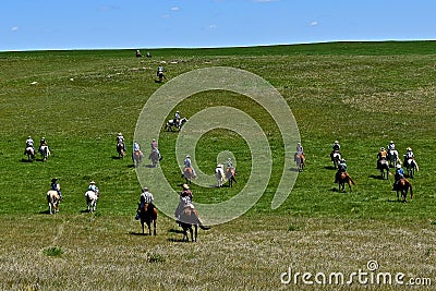 Riders and horses headed to a roundup Stock Photo