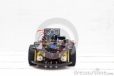 A riding robot on four wheels on a light background Stock Photo