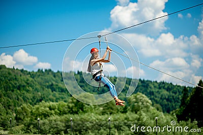 Riding on a zip line Stock Photo