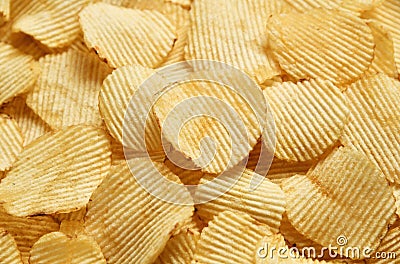 Riffle golden chips with texture potato background Stock Photo