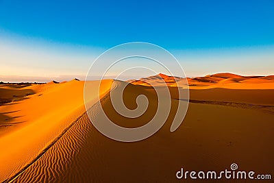 Orange dune ridge with riffles in the desert of Sahara, Morocco Stock Photo