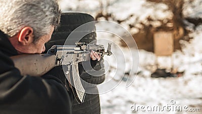 Rifle tactical shooting training behind and around cover or barricade Stock Photo