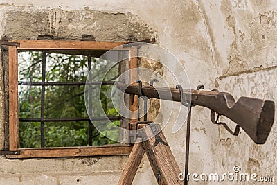 Rifle shooting from window Stock Photo