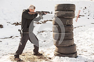 Rifle tactical shooting training behind and around cover or barricade Stock Photo