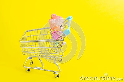 Riga, Latvia - April 18 2019: Little doll sitting in mini shopping trolley Editorial Stock Photo