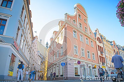 Riga, Latvia - August 10, 2014 - famous narrow medieval architecture building street with church towers in old town Riga, Latvia. Editorial Stock Photo