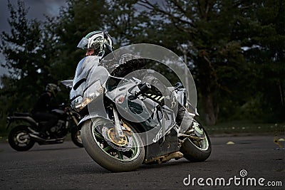 10-05-2021 Riga, Latvia biker rides motorcycle, motorcyclist side view, close up of bike rides motorcycle, motorcyclist side view Editorial Stock Photo