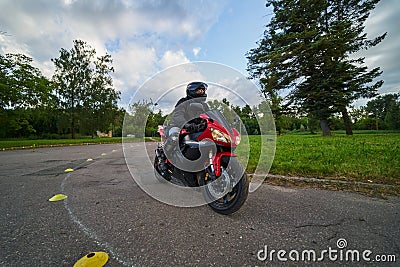 10-05-2021 Riga, Latvia biker rides motorcycle, motorcyclist side view, close up of bike rides motorcycle, motorcyclist side view Editorial Stock Photo