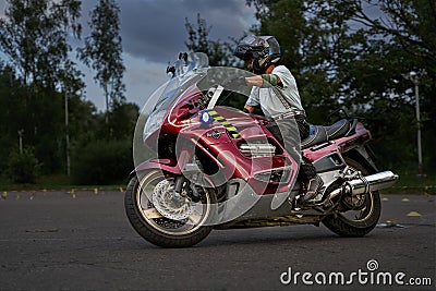 10-05-2021 Riga, Latvia biker rides motorcycle, motorcyclist side view, close up of bike rides motorcycle, motorcyclist side view Editorial Stock Photo