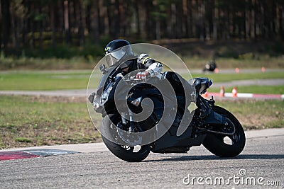 19.09.2020 Riga Latvia Handsome motorcyclist in black riding his super sport motorcycle Editorial Stock Photo