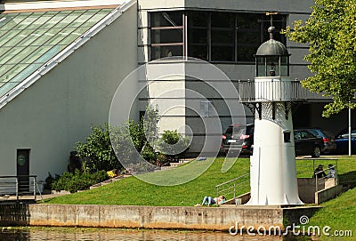 Riga, Latvia - July 10, 2017: The lighthouse at the building of Freeport of Riga Authority on city canal of Riga at Kronvalda Park Editorial Stock Photo