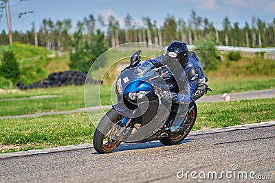 12-05-2020 Riga, Latvia. man on a motorbike on the road riding. having fun driving the empty road on a motorcycle tour journey Editorial Stock Photo