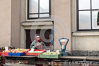 RIGA, LATVIA - MARCH 3, 2015: Unknown trader standing behind the counter and read the newspaper Editorial Stock Photo
