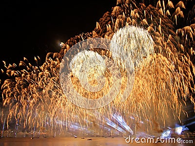 Gorgeous multi-colored light show and fireworks display on dark night sky over the river Daugava Stock Photo