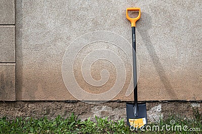 Digging spade at the wall of house from Fiskars collection Editorial Stock Photo