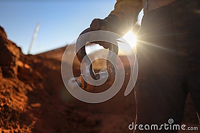 Rigger holding crane lifting 17 tone shackle sunset at the back ground Stock Photo