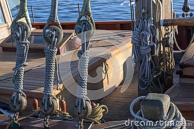 Rigging, ropes and knots on a historical wooden sailing ship on a sunny day on the sea Stock Photo