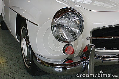 Right front headlight and part of front chrome buffer on german luxury two door roadster Mercedes Benz 190 SL from year 1961 Editorial Stock Photo