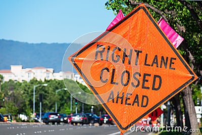 Right Lane Closed Ahead warning road sign on wide city street in urban neighborhood Stock Photo