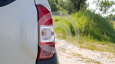 Right rear headlight. The rear of a small passenger hatchback or SUV of a white car with a group of taillights and a part of the Stock Photo