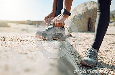 The right shoes determine your run. a woman tying her shoe laces before a jog. Stock Photo