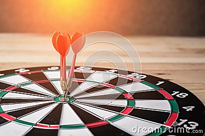Right on target concept using dart in the bullseye on dartboard Stock Photo