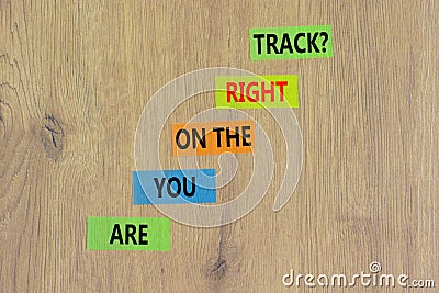 Right track symbol. Concept words Are you on the right track on colored paper on a beautiful wooden table wooden background. Copy Stock Photo