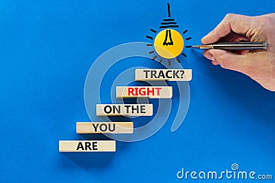 Right track symbol. Concept words Are you on the right track on wooden blocks on a beautiful blue table blue background. Stock Photo