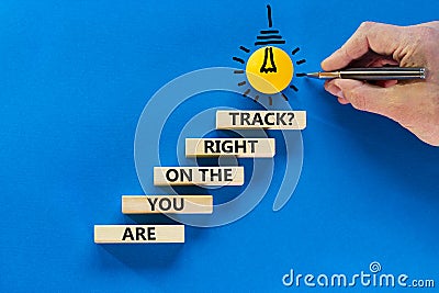 Right track symbol. Concept words Are you on the right track on wooden blocks on a beautiful blue table blue background. Stock Photo