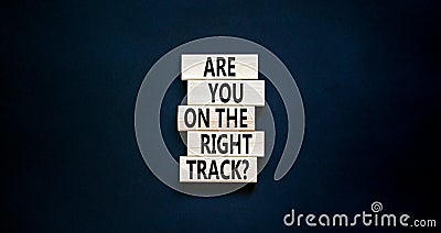 Right track symbol. Concept words Are you on the right track on wooden blocks on a beautiful black table black background. Copy Stock Photo