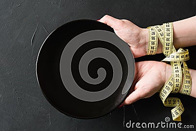 Rigid diet fasting weightloss hands empty plate Stock Photo