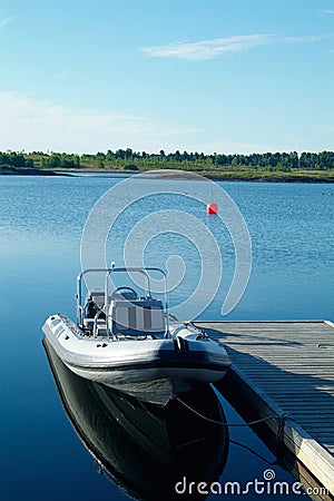 Rigid inflatable boat at a pier Stock Photo
