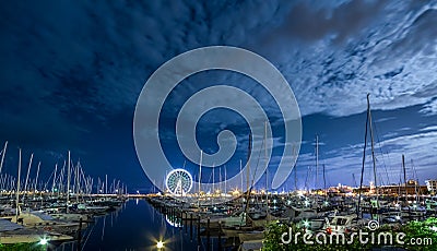 RIMINI, night view of marina with ferris wheel Stock Photo
