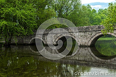 Rimski most or Roman bridge reflecting in the Bosna river Stock Photo